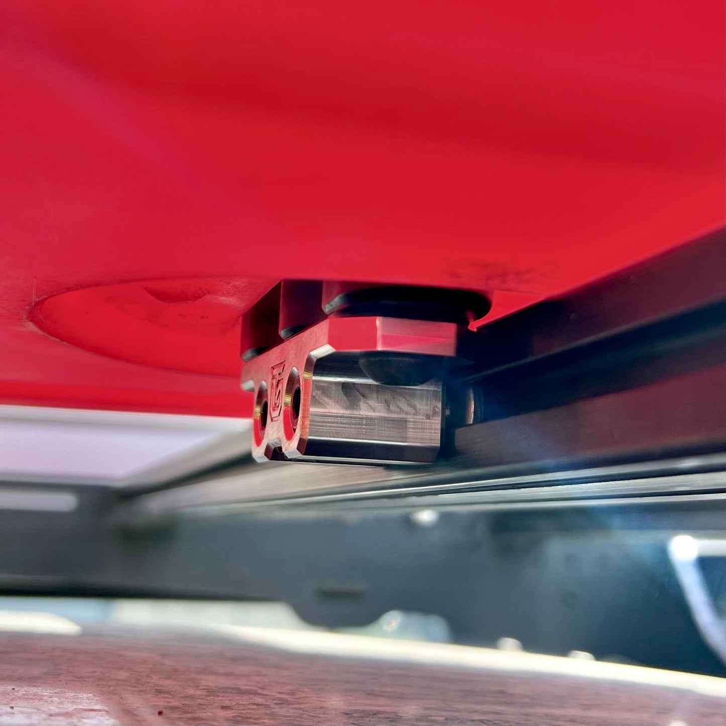 Billet aluminum Rotopax mount adapter for extrusion roof rack cross bars.