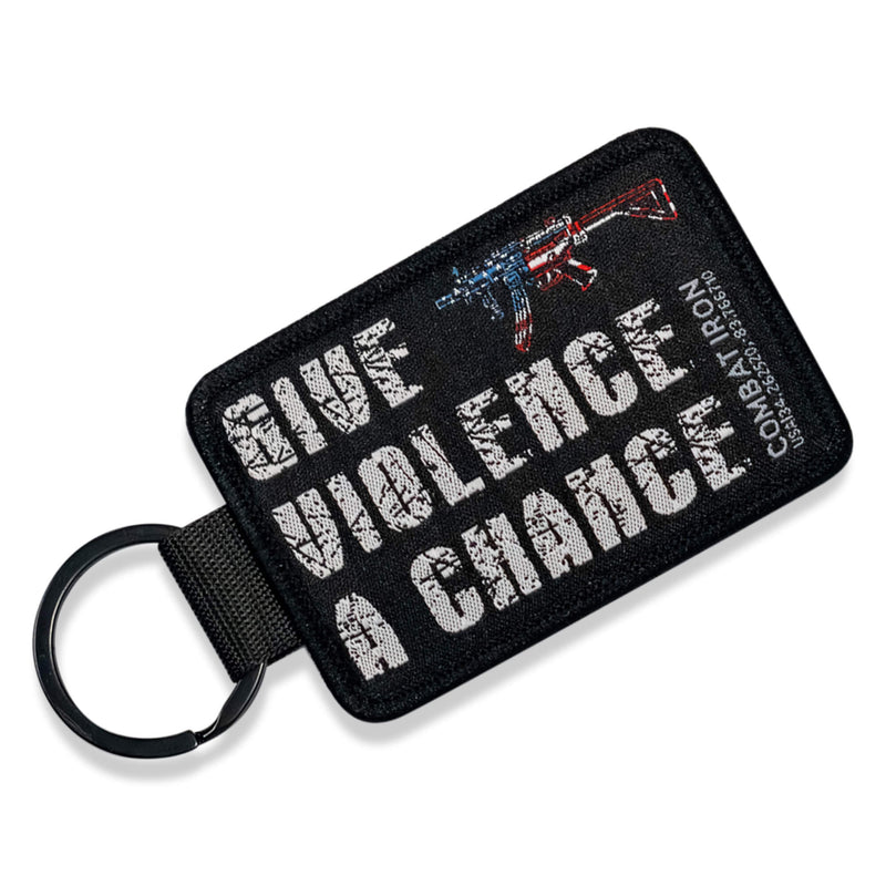 Load image into Gallery viewer, Give Violence A Chance Flight Tag Keychain