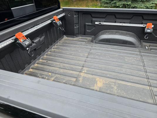 Truck bed tie down system