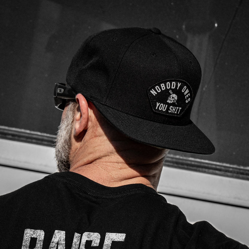 Load image into Gallery viewer, Nobody Owes You Shit Arched Patch Flatbill SnapBack Hat
