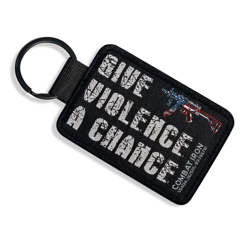 Load image into Gallery viewer, Give Violence A Chance Flight Tag Keychain
