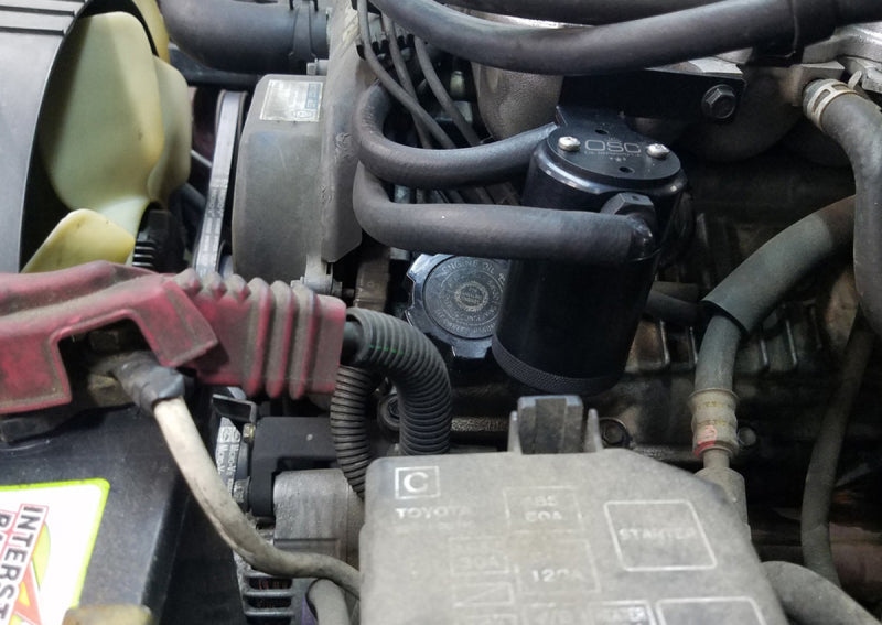 Load image into Gallery viewer, J&amp;L 95-04 Toyota Tacoma/4Runner 3.4L Driver Side Oil Separator 3.0 - Black Anodized
