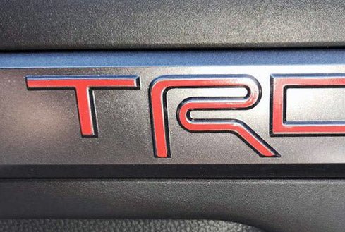 Load image into Gallery viewer, Premium Cast Vinyl Decal Letter Inlays for 2024-2026 Tacoma TRD Interior Door Emblems
